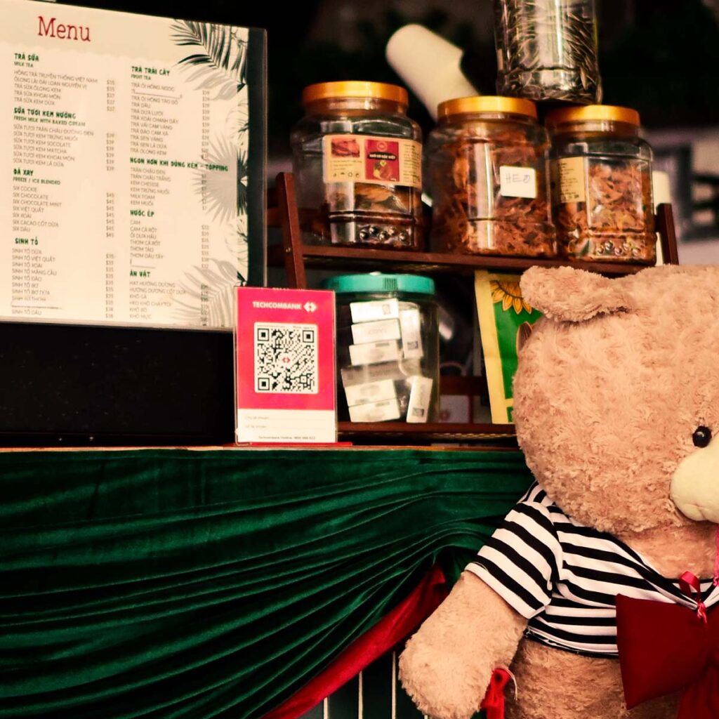 A custom printed QR code displayed on a restaurant counter next to a menu, allowing customers to easily leave a review using a free QR code generator.